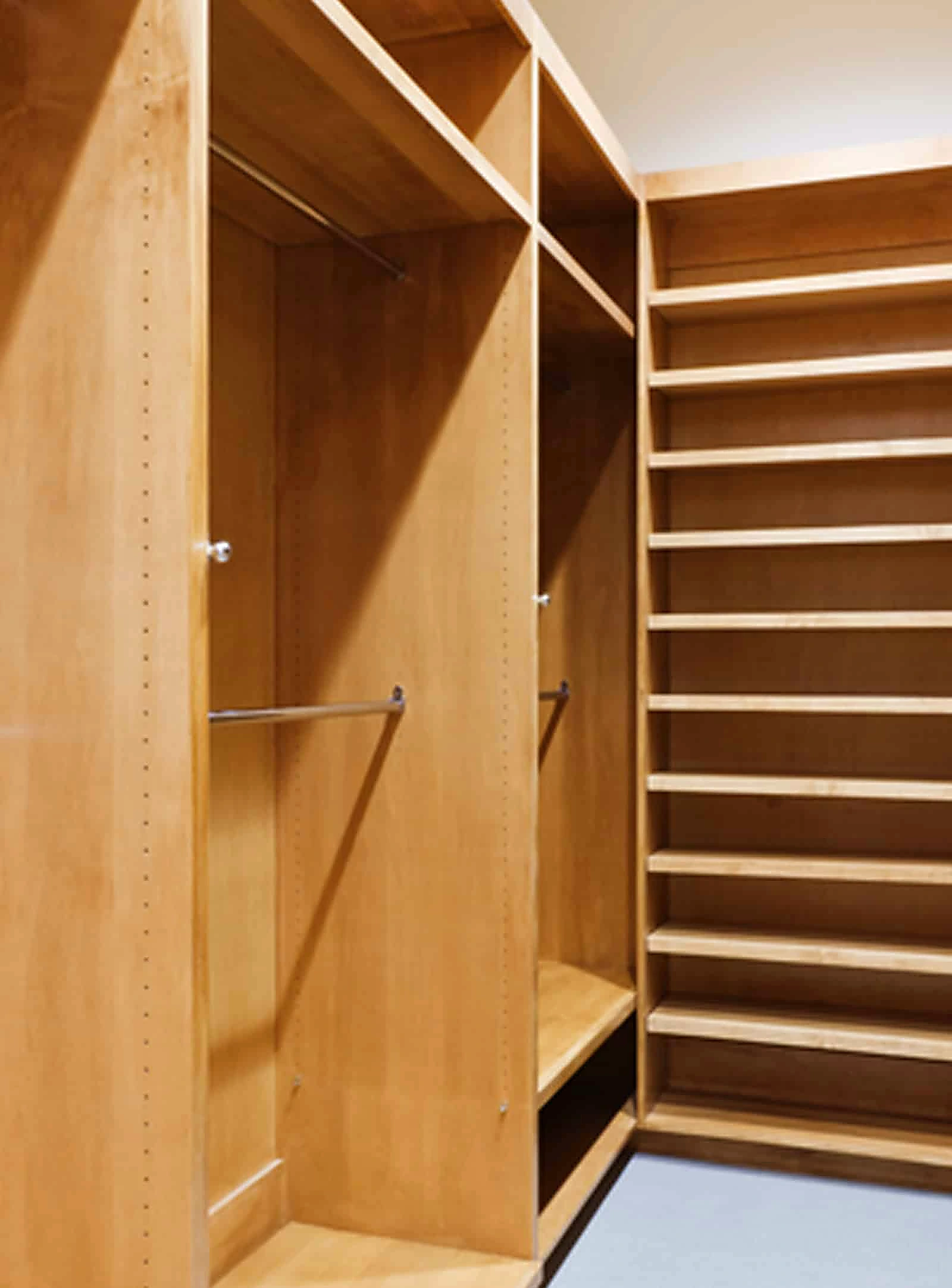 Warm wood closet cabinetry with integrated shelving