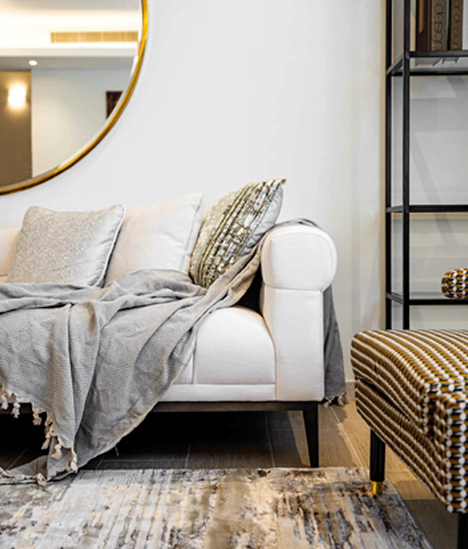 Curated sitting area with layered textiles and warm neutrals